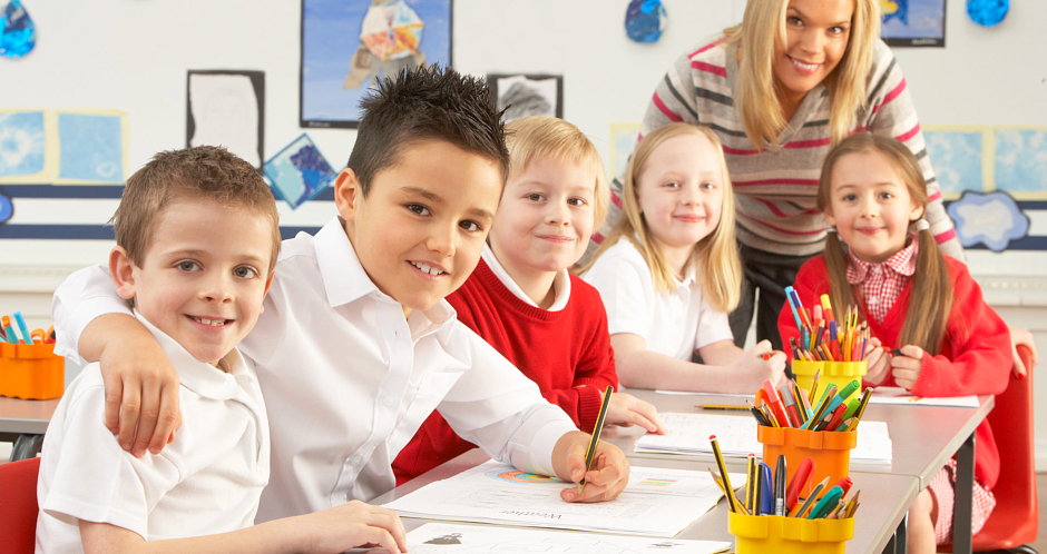 children making an artwork with their teacher