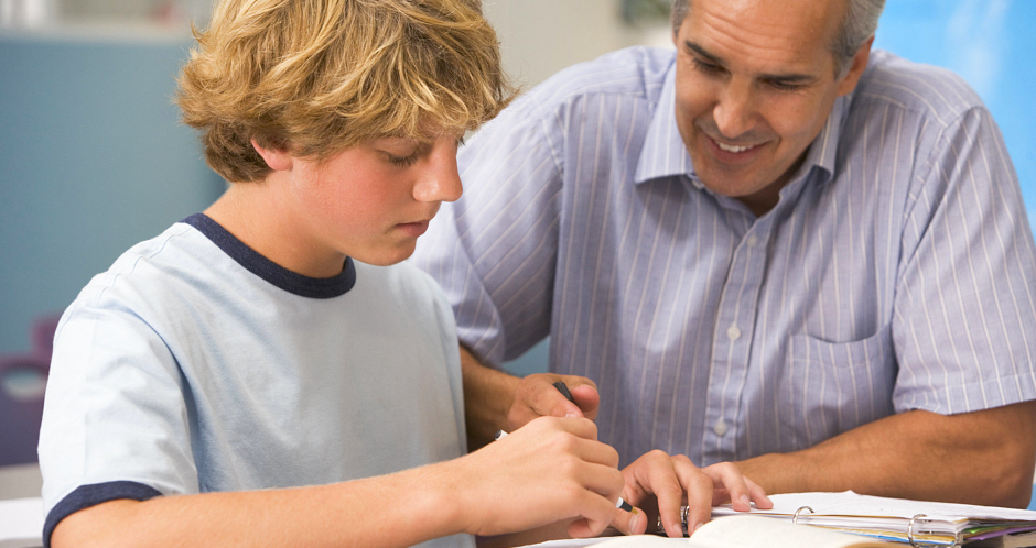 teacher teaching the boy how to solve the problem